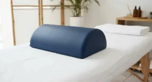 Half-round massage table knee bolster providing stable support and preventing roll during treatment.